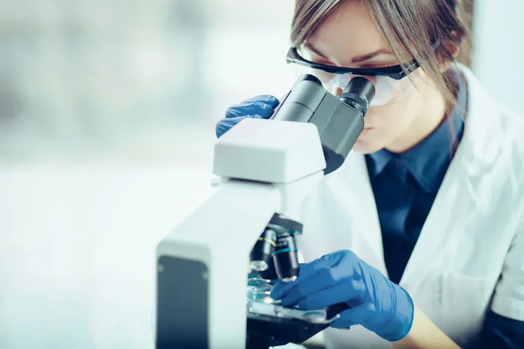 Scientist looking through a microscope